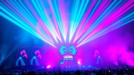 Stage lights and crowd of people in front of a live concert stage