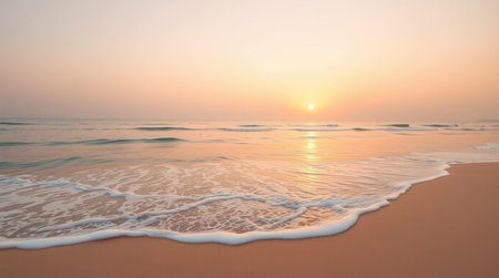 Beautiful sunset on the beach with soft wave of sea and sand