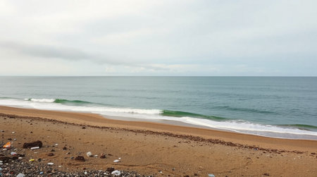 View of the sea from the sand of the beach on a cloudy day