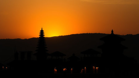 Buddhist temple in the evening with a fountain in the foregroundの写真素材