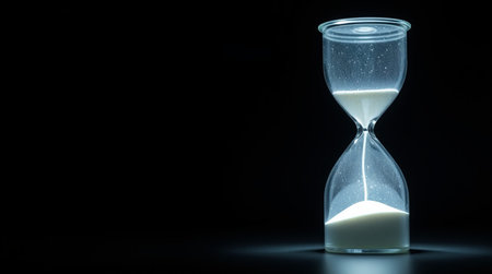Hourglass on black background with copy space. Time management concept.