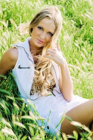 Beautiful woman laying in the grassの写真素材