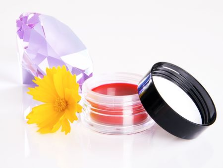 Jar of red rouge with a flower and violet crystalの写真素材