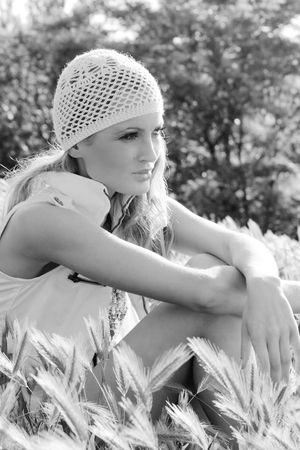 Monochrome picture of a beautiful thoughtful woman relaxing outdoorsの写真素材