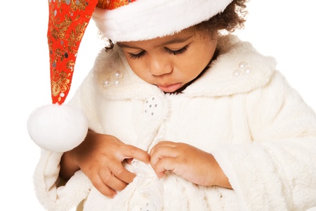Portrait of a cute baby in Christmas hat and fur on white background の写真素材