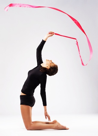 Young gymnast woman doing an exercise with ribbonの写真素材