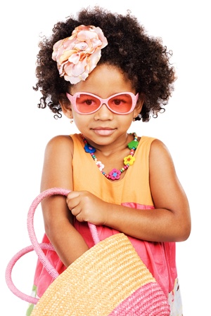 Lovely stylish little girl getting something from her straw bagの写真素材