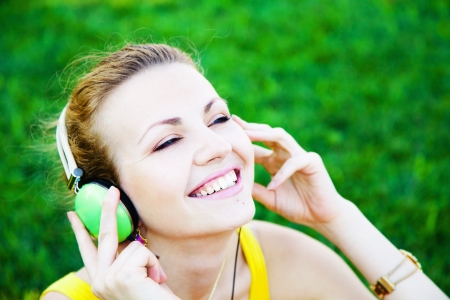 Young beautiful woman enjoing the music outdoorsの写真素材