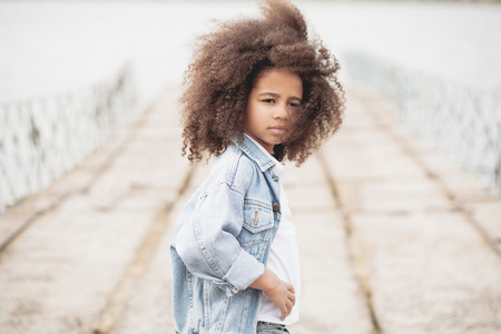 Outdoor portrait of a beautiful stylish little girlの写真素材