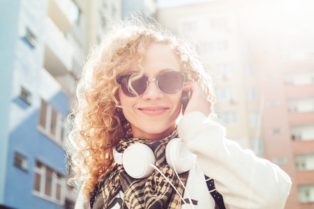 Lovely woman talking on the phone in the street. Closeup pictureの写真素材