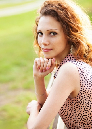 Young lovely woman in city parkの写真素材