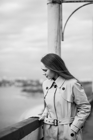 Beautiful woman on the bridge. Black and white picture with film grain imitation.の写真素材