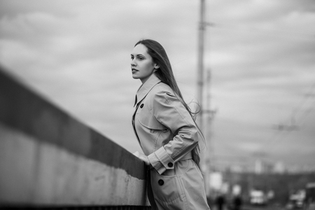Beautiful woman on the bridge. Black and white picture with film grain imitation.の写真素材