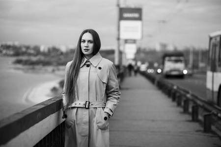Beautiful woman on the bridge. Black and white picture with film grain imitation.の写真素材