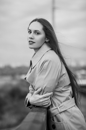 Beautiful woman on the bridge. Black and white picture with film grain imitation.の写真素材