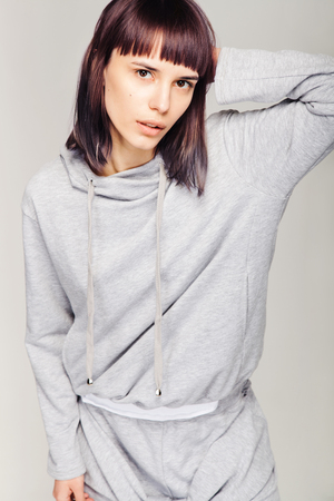 Young beautiful fashion girl in gray sporty outfitの写真素材