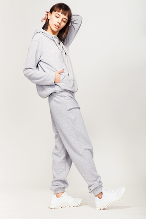 Young beautiful fashion girl in gray sporty outfitの写真素材