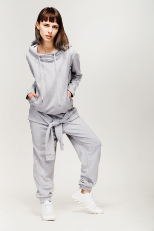 Young beautiful fashion girl in gray sporty outfitの写真素材