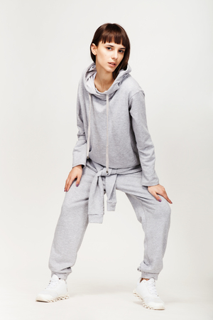 Young beautiful fashion girl in gray sporty outfitの写真素材