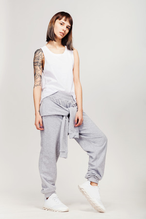 Young beautiful fashion girl in gray sporty outfitの写真素材