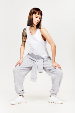 Young beautiful fashion girl in gray sporty outfitの写真素材