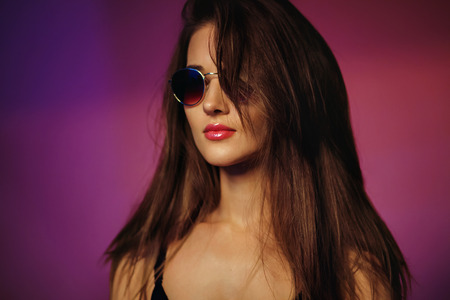 Summer girl. Portrait of a pretty woman in sunglasses with beautiful hairの写真素材