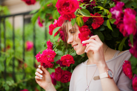 Portrait of a beautiful tender woman in rose gardenの写真素材