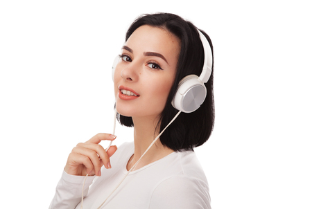 Young beautiful woman in headphones against white backgroundの写真素材