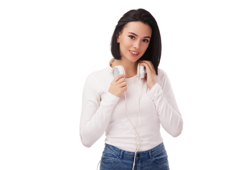 Young beautiful woman with headphones against white backgroundの写真素材