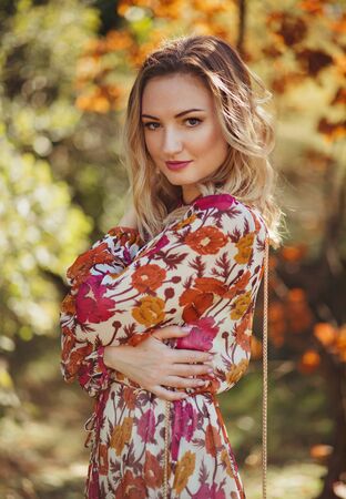 Outdoor romantic portrait of beautiful woman in autumn parkの写真素材