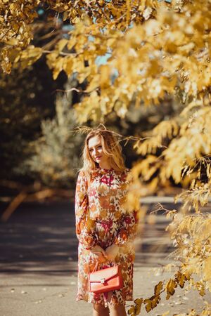 Outdoor portrait of beautiful woman in the autumn streetの写真素材