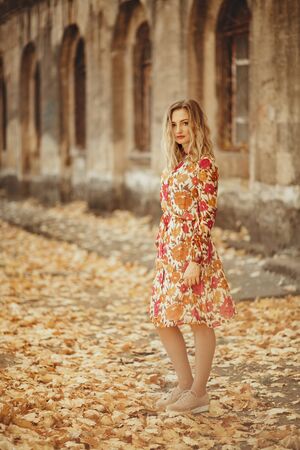Outdoor portrait of beautiful woman in the autumn streetの写真素材