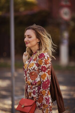 Outdoor portrait of beautiful woman in the autumn streetの写真素材