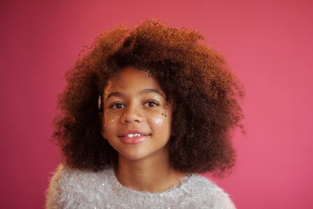 Cute girl with shiny makeup against bright pink backgroundの写真素材