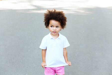 Outdoor portrait of cute little girl in white t-shirtの写真素材