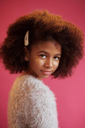 Beautiful girl with shiny makeup against bright pink backgroundの写真素材