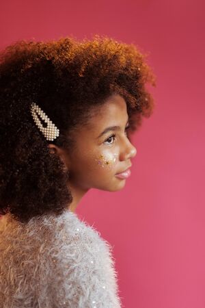 Beautiful girl with shiny makeup against bright pink backgroundの写真素材