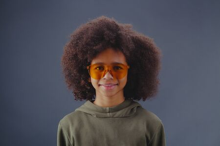 Studio portrait of happy cute girl wearing bright sunglassesの写真素材