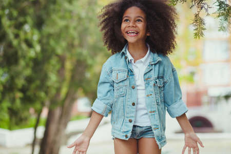 Little girl full of happines and excitement. Outdoor picture.の写真素材