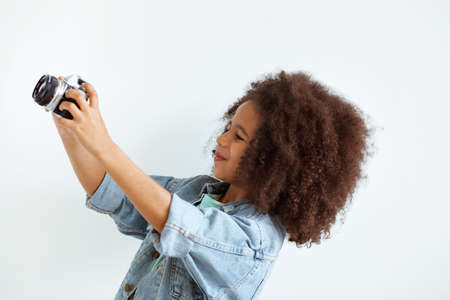 Lovely girl taking a picture with retro cameraの写真素材