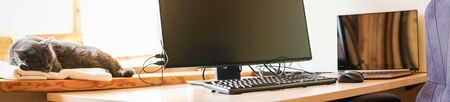 Working place with IT equipment at home is used as homebase office. Flexible hours and remote working concept. Panoramaの写真素材