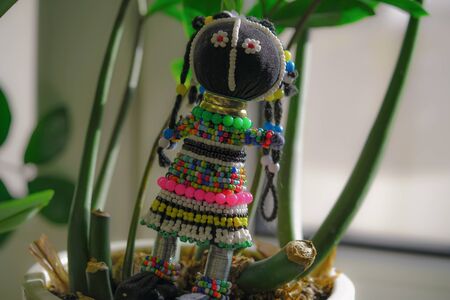Souvenir from South Africa, doll in a traditional national dress made of beads. Horizontal imageの写真素材