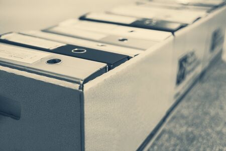 Documents preservation in archive. Office dcuments are filing in ring binders and box containers are...