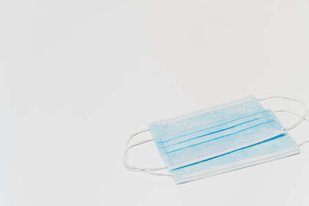 Blue medical face mask on white background, virus protection. Isolated and copy space color image.の写真素材