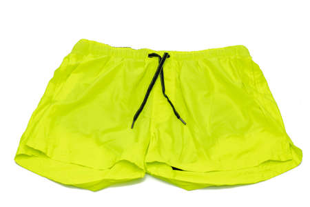 A man's swimsuit, fluorescent yellow. Isolated on white background. Male fashion concept.の写真素材