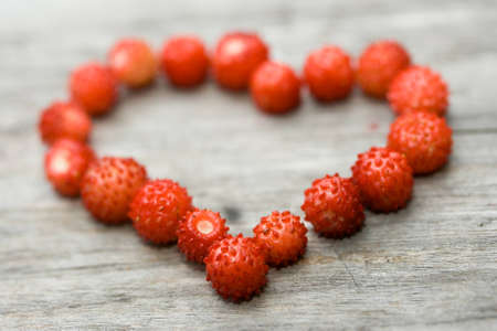 Sweet heart made of wild strawberries close up