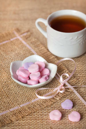 Heart-shaped sweets on sack tableclothの写真素材