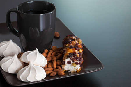 Black Cup with Meringues, Almonds and Marshmallowの写真素材