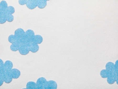 Blue Felted Clouds on White Backgroundの写真素材