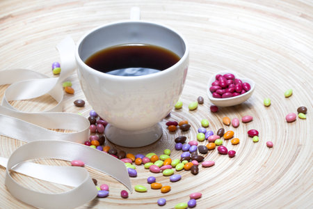 Cup of Coffee and Candies Heart on Wooden Backgroundの写真素材